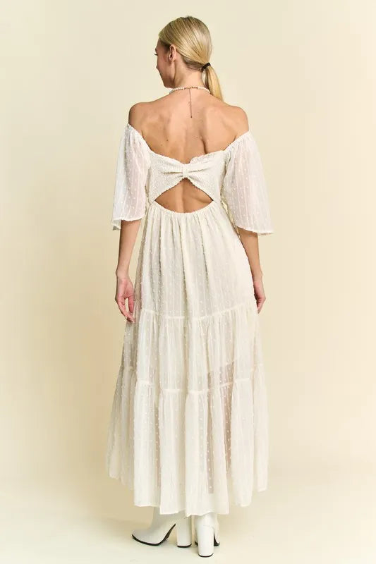  The swiss dotted pattern adds a whimsical and delicate touch to the dress. The ruched detailing creates a figure-flattering silhouette. 