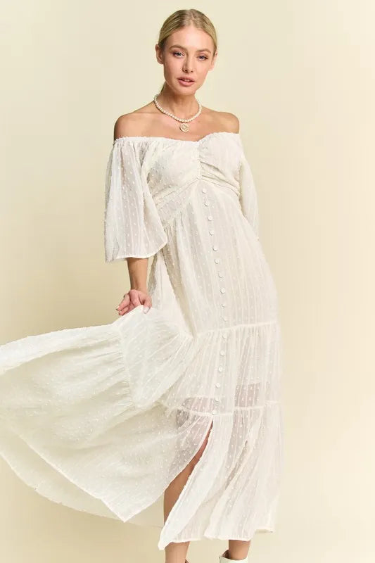  The swiss dotted pattern adds a whimsical and delicate touch to the dress. The ruched detailing creates a figure-flattering silhouette. 