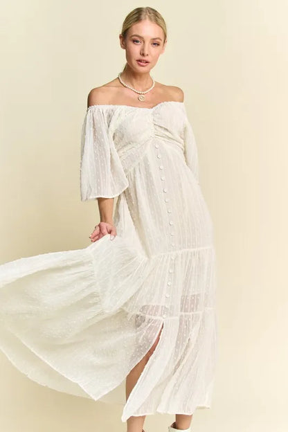  The swiss dotted pattern adds a whimsical and delicate touch to the dress. The ruched detailing creates a figure-flattering silhouette. 