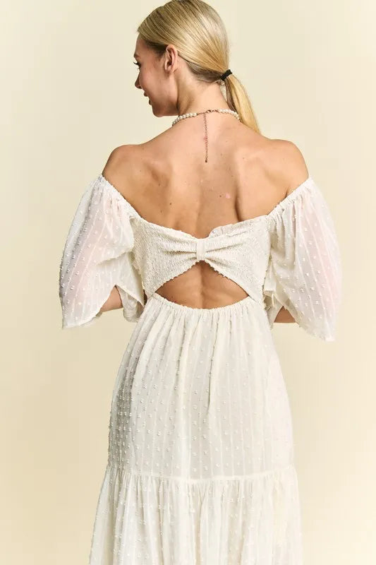  The swiss dotted pattern adds a whimsical and delicate touch to the dress. The ruched detailing creates a figure-flattering silhouette. 