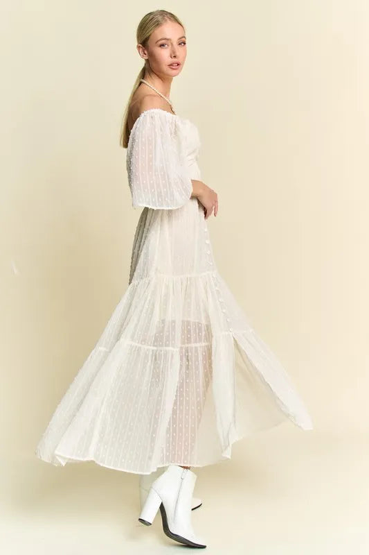 The swiss dotted pattern adds a whimsical and delicate touch to the dress. The ruched detailing creates a figure-flattering silhouette. 